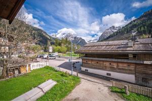 an old building with a mountain in the background at Casa Cesarina by AMA Val di Fassa in Canazei