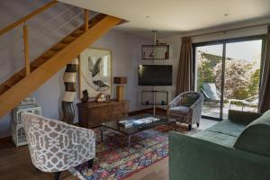 a living room with a couch and a tv at La Mare aux Oiseaux, The Originals Collection in Saint-Joachim
