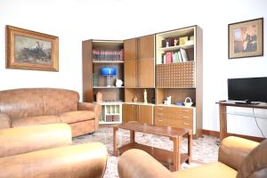 a living room with a couch and a tv at SE274 - Marotta, ampio quadrilocale con posto auto in Marotta