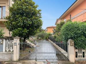 a gate to a walkway with trees on it at SE274 - Marotta, ampio quadrilocale con posto auto in Marotta