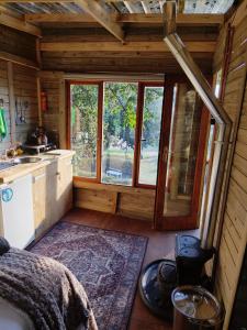 a kitchen with a large window in a cabin at Tree house Living in Roodepoort