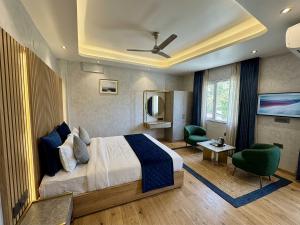 a hotel room with a bed and a living room at V Hotel Dev Residency Airport Pick up complimentary in New Delhi +26 photos