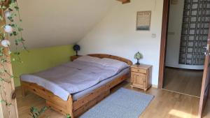a bedroom with a wooden bed and a night stand at sPokój na Marsa in Straszyn