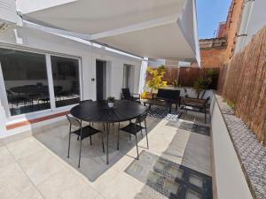 a patio with a black table and chairs at Apartaments IXA in Manresa