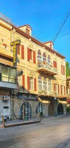 a large building with balconies on the side of it at Hotel St Jean in Zahlé