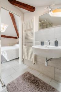 a white bathroom with a sink and a bedroom at Lake View - Gardone Center - Private Garage in Gardone Riviera +23 photos