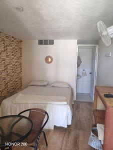 a bedroom with a bed and a table and chairs at Villa Naylamp loft8 playa pocitas in Máncora +62 photos