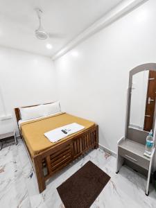 a room with a bed with a mirror and a table at LS Residency Ac in Thiruchendur