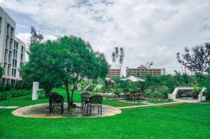 a group of chairs sitting in a park at Omtush Suites 002 in Marimbeti