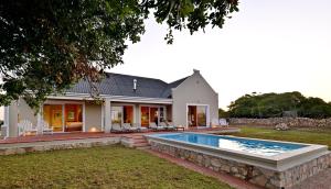 a house with a swimming pool in the yard at De Hoop Collection in De Hoop Nature Reserve