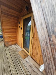 an inside view of a wooden cabin with a door at Mountain Edge Resort Mega pod 5 with Hot Tub in Church Stretton
