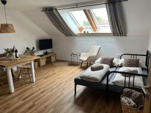 a room with a bed and a desk and a table at Upekla in Přibyslav