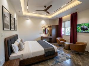 a hotel room with a bed and a chair at V Hotel Dev Residency Airport Pick up complimentary in New Delhi