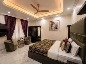 a bedroom with a bed and a ceiling fan at V Hotel Dev Residency Airport Pick up complimentary in New Delhi