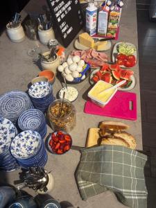 a table topped with lots of different types of food at Smedjan affären in Varberg