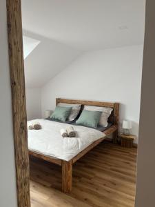 a bedroom with a bed with two slippers on it at Upekla in Přibyslav