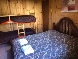 a bedroom with a bed and two bunk beds at Casa Azul in Potrerillos