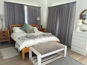 a bedroom with a bed with a laptop on it at Sundowner in Yzerfontein
