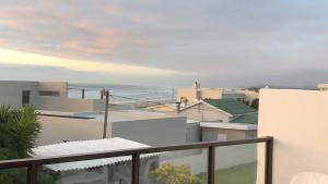 a view of the ocean from the balcony of a house at Sundowner in Yzerfontein
