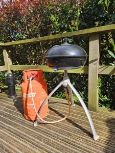 a grill sitting on top of a wooden deck at Mountain Edge Resort Mega pod 1 with Hot Tub in Church Stretton