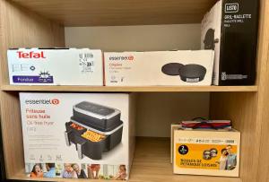 a shelf in a store with a toaster and a box at Le Courlis du Ried in Grussenheim