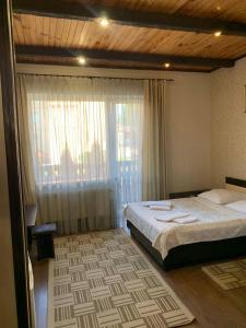 a bedroom with a bed and a large window at versal in Ternopil +40 photos