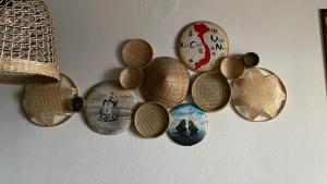a bunch of cork plates hanging on a wall at Vina am Ring in Mannebach