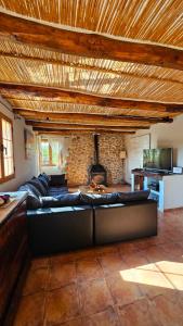 a living room with a couch and a fireplace at Sa Sort Llarga in Moscari