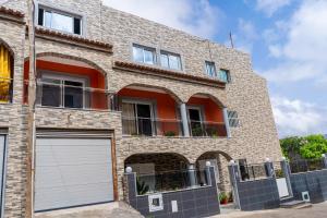 a brick house with two garage doors in front at Appartement Chanel in Assomada