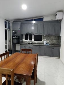 a kitchen with a wooden table and a dining room at Apartamento Cidadela in Praia