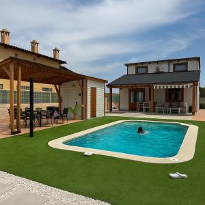 a person in a swimming pool in a house at Luxury Rural Cuenca - Villas in Cuenca