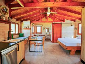 a kitchen and living room with a bed and a table at Luxury Rural Cuenca - Villas in Cuenca