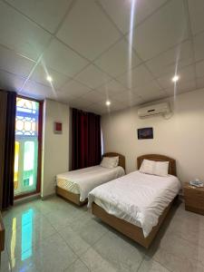 a hotel room with two beds and a window at Hotel St Jean in Zahlé +41 photos