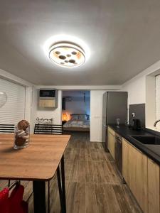 a kitchen with a table and a kitchen with a bed at Le Clos de Bourgueil in Sainte-Anne