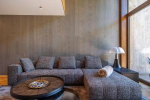 a living room with a couch and a dog laying on a table at Isard Penthouse & Spa in El Tarter