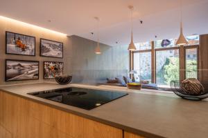 a kitchen with a counter with a sink in it at Isard Penthouse & Spa in El Tarter