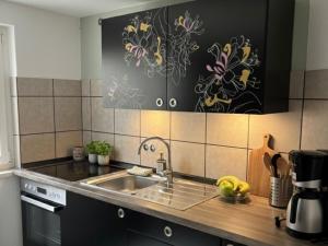 a kitchen with a sink and a counter top at Wellness -Residenz Ehrhardt Urlaub mit Pool und Garten Ferienwohnung im Herzen von Halberstadt in Halberstadt