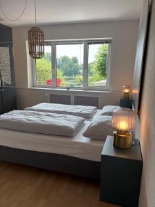 a bedroom with a large bed and a window at Hotel Am Mühlenteich in Lübeck +20 photos
