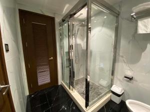 a glass shower in a bathroom with a toilet at High Class 1BR at One Euphoria in Angeles