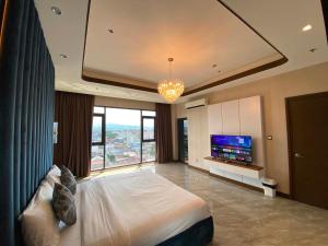 a large bedroom with a large bed and a television at High Class 1BR at One Euphoria in Angeles