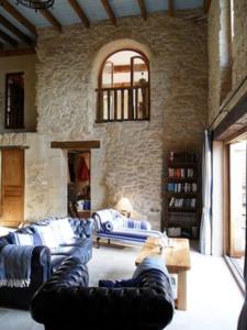 a living room with a cat sitting on a couch at '1786' au bourg in Mansonville