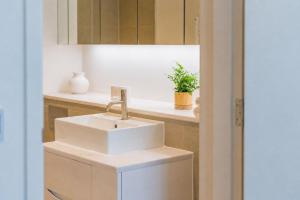 a bathroom with a white sink and a counter at The View at Shoreline by Bloom Stays in Folkestone