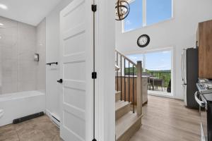 a bathroom with a staircase and a tub and a window at Apex Nuage - Spa Game Room & Panoramic Views in Saint Come