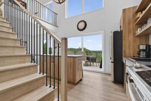 a kitchen with stairs leading to a dining room at Apex Nuage - Spa Game Room & Panoramic Views in Saint Come +42 photos