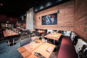 a dining room with wooden tables and chairs at 3100 Kulmhotel Gornergrat in Zermatt