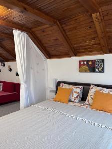 a bedroom with a bed and a red couch at Ravne Konak in Visoko