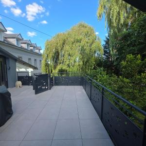 a walkway with a fence and trees on it at Jardin De Pairis in Orbey