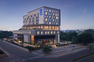 a rendering of a hotel with a building at Novotel Bhubaneswar Janpath in Bhubaneshwar
