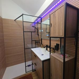 a bathroom with a sink and a shelf with lights at Jardin De Pairis in Orbey +15 photos