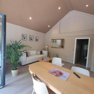 a living room with a table and a couch at Jardin De Pairis in Orbey